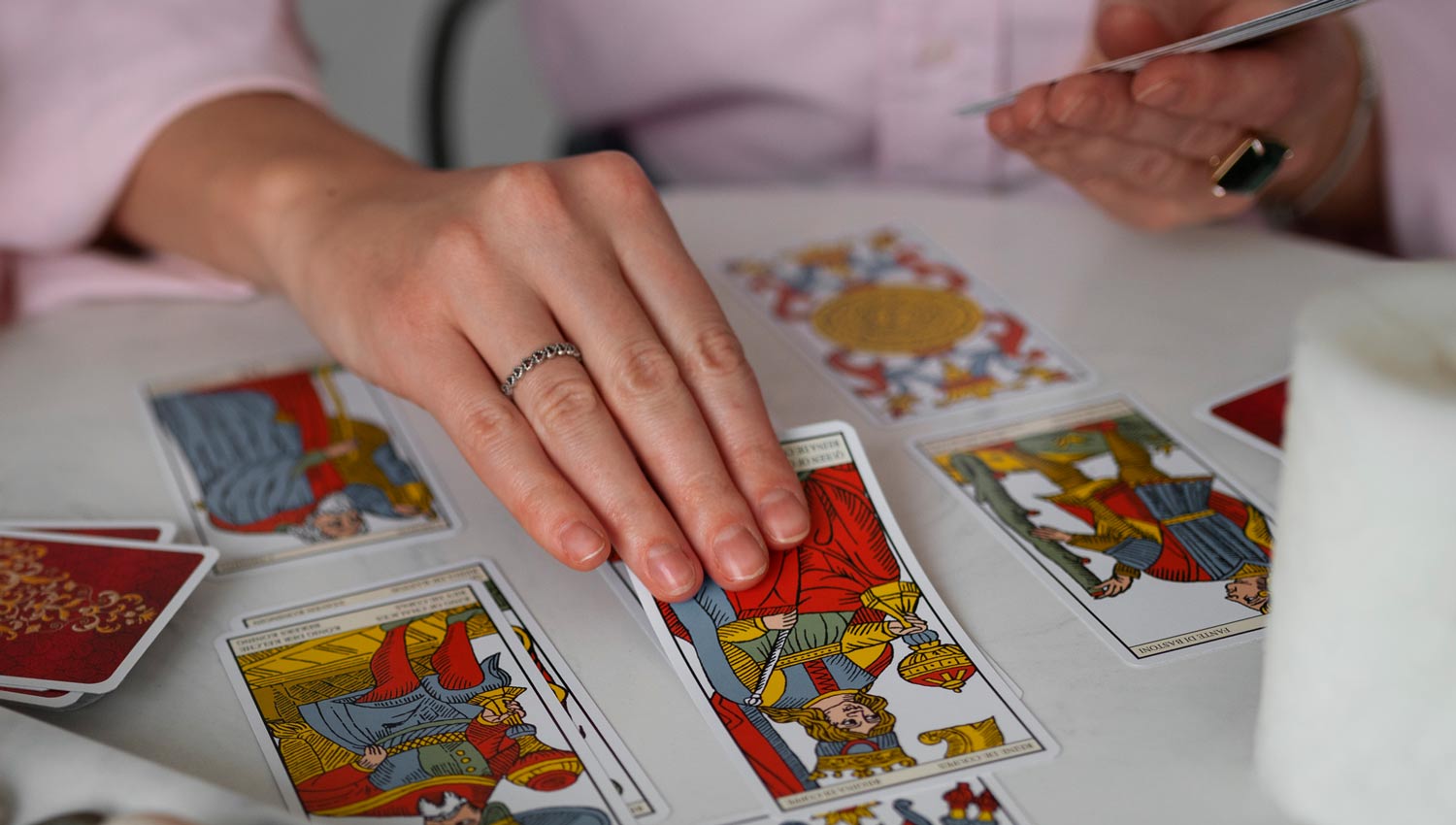 A tabletop scene with face-up tarot cards, capturing a thoughtful and reflective mood during a tarot card pull.