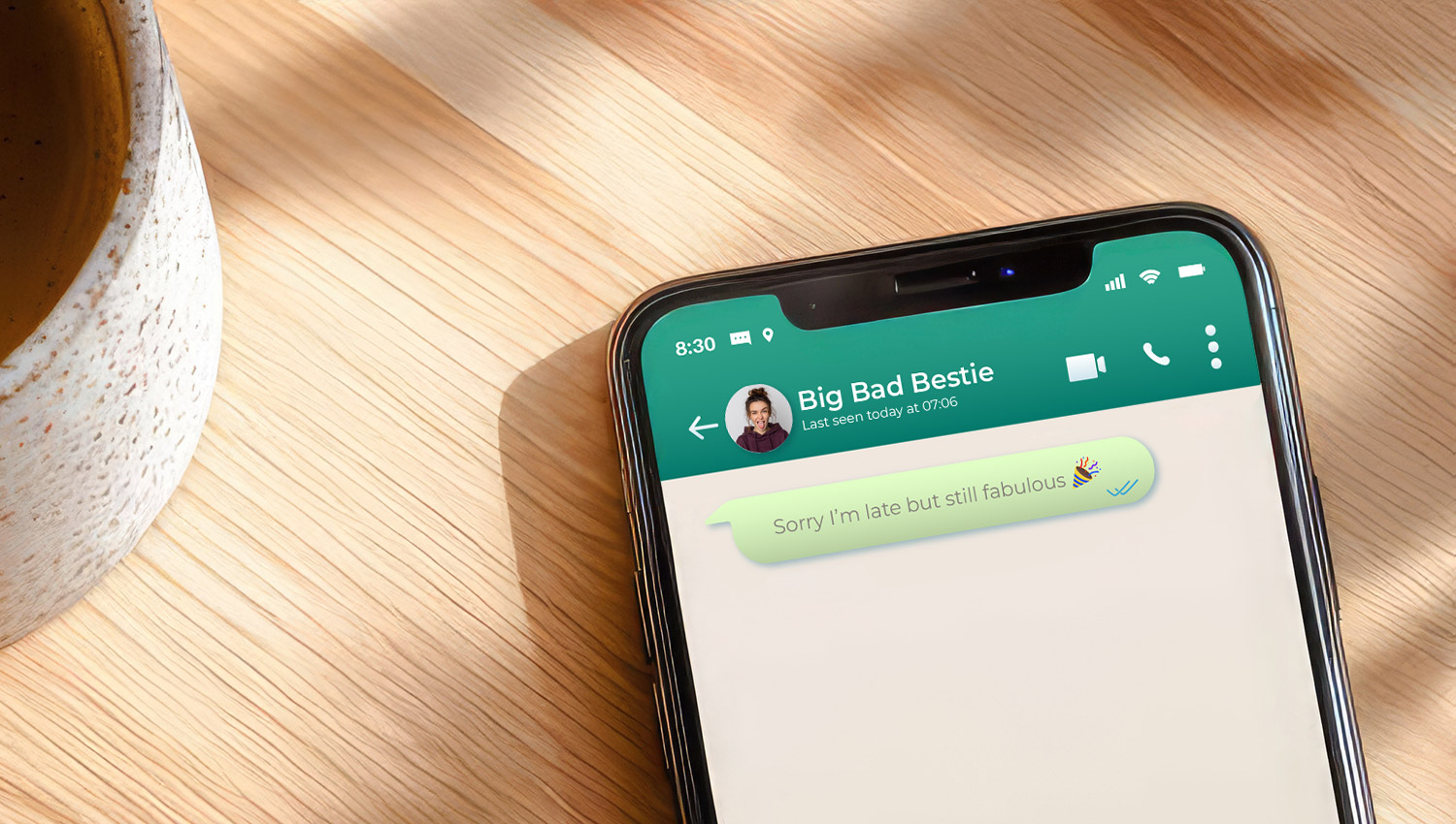 Phone with colorful text message bubbles showing a fun belated birthday message