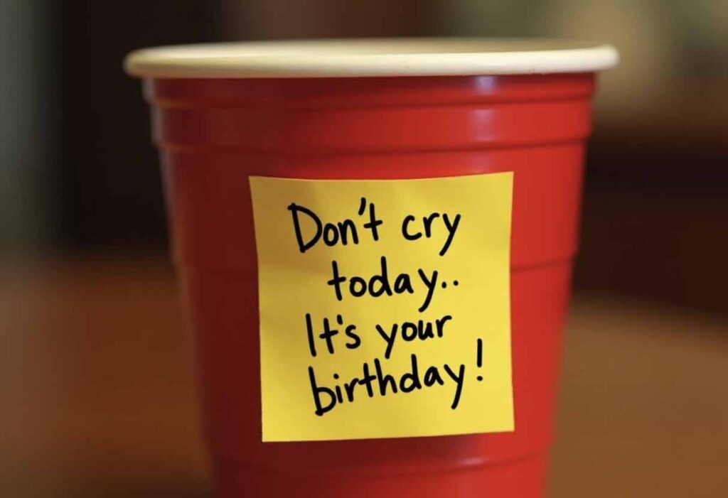 Sticky note on a red solo cup reading “Don’t cry today. It’s your birthday.”
