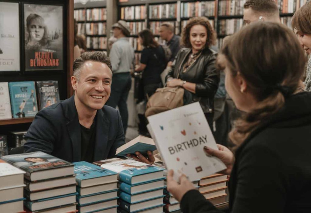 Realistic candid photo of a small group casually clinking glasses at a cozy gathering. Natural lighting, warm tones, soft focus on the hands and glasses. No posing—just genuine smiles, relaxed vibe, and ambient chatter in the background.