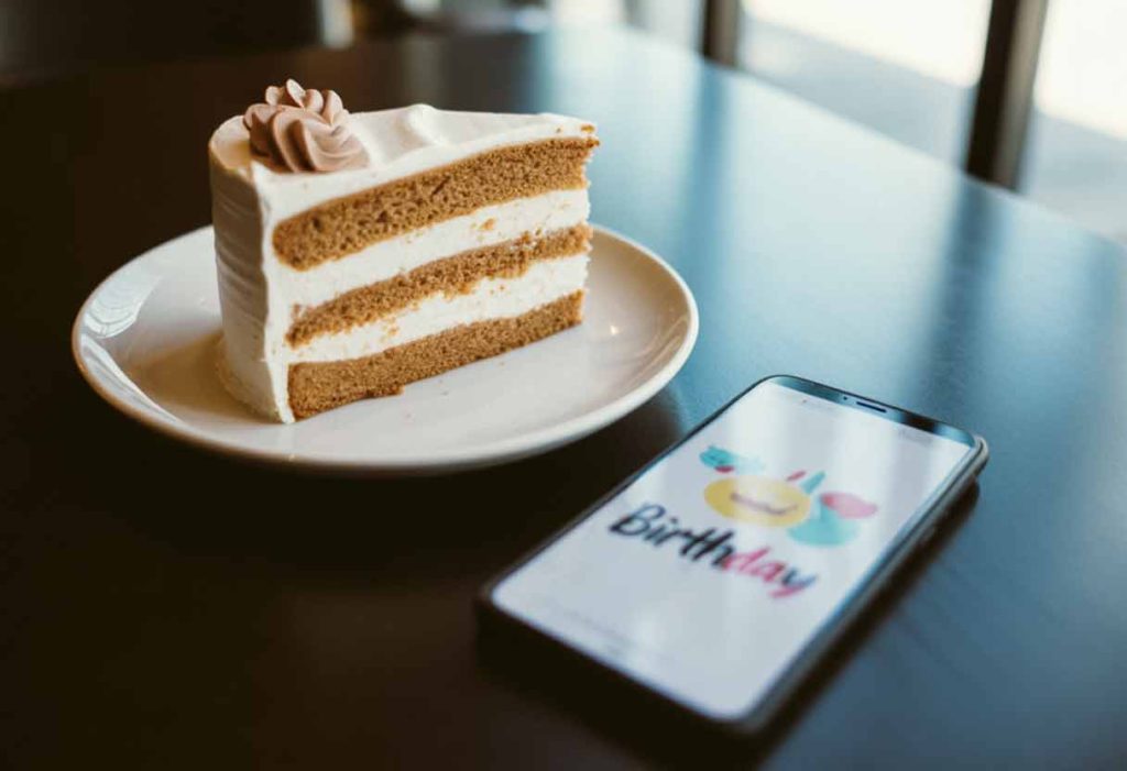 A small slice of birthday cake on a plate