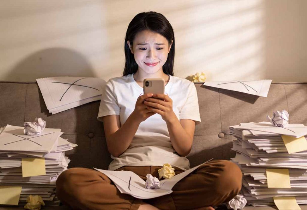 a person on a couch surrounded by crumpled sticky notes